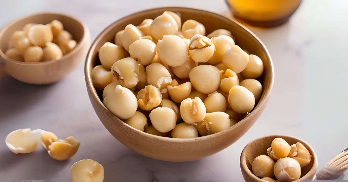 A bowl filled with whole and cracked macadamia nuts, highlighting their smooth, creamy texture and rich, golden color, showcasing their natural, wholesome appeal.