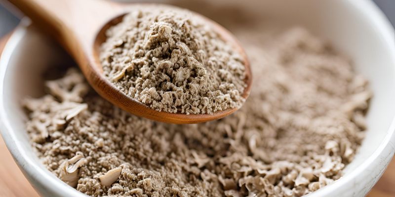 A small bowl of finely ground mushroom powder on a wooden spoon, ready to be sprinkled over pasta, roasted vegetables, or soups for an added umami boost.